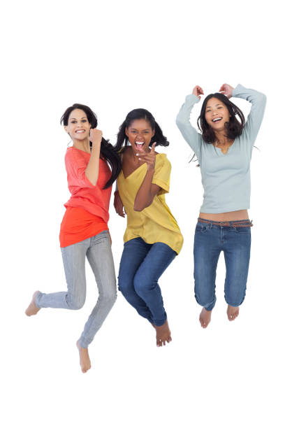 istock Diverse young women jumping and looking at camera 832656730