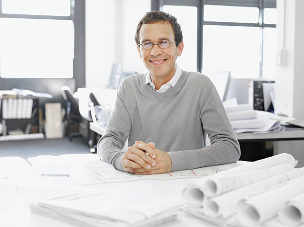 architect posing with blueprints - arsitek foto potret stok, foto, & gambar bebas royalti