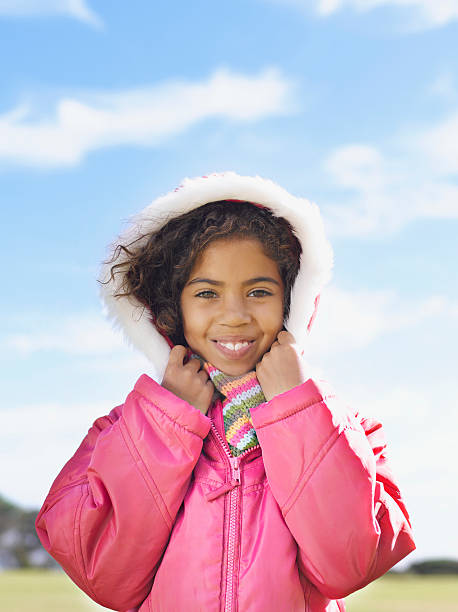 Young girl smiling in warm winter coat  kids winter coat stock pictures, royalty-free photos & images