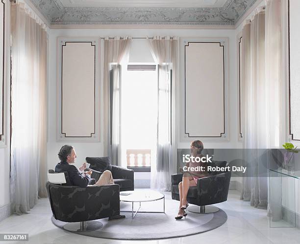 Couple Drinking Coffee In Sitting Room Stock Photo - Download Image Now - Luxury, Elegance, Living Room