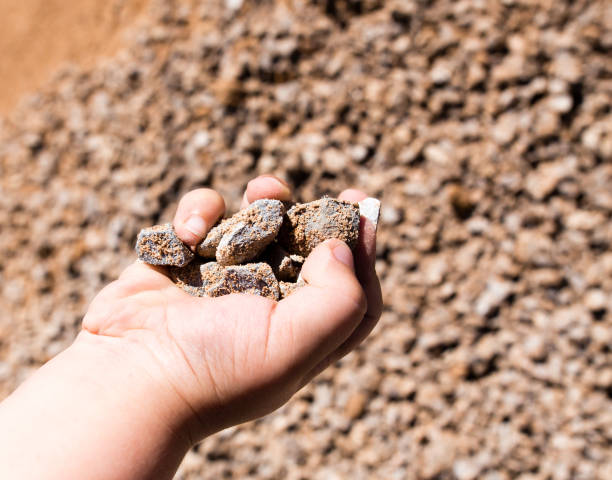 istock Building crushed stone with sand in hand 832675722
