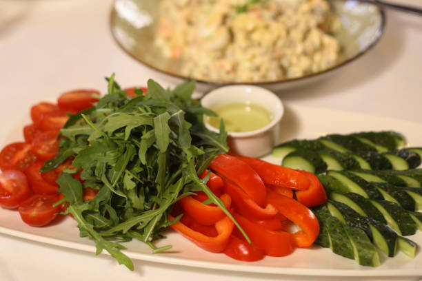 cucumber tomato pepper sweet cut salad close up photo on plate with olive oil