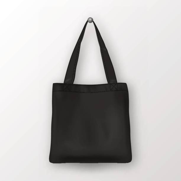 Realistic vector black empty textile tote bag. Closeup isolated on white background. Design template for branding, mockup. EPS10 Realistic vector black empty textile tote bag. Closeup isolated on white background. Design template for branding, mockup. EPS10 illustration. tote bag mock up stock illustrations