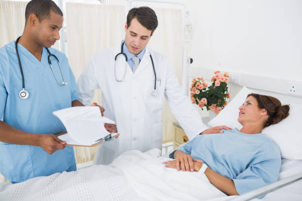 istock Doctors visiting female patient in hospital 832716656