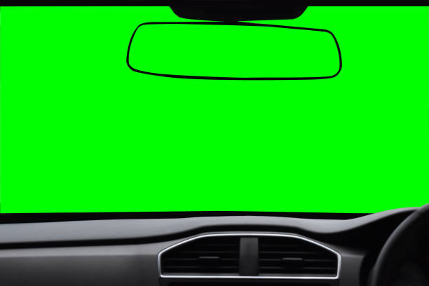 istock Windshield and rear view mirror ,View inside the car with green scree Isolated on background with clipping path 832787160