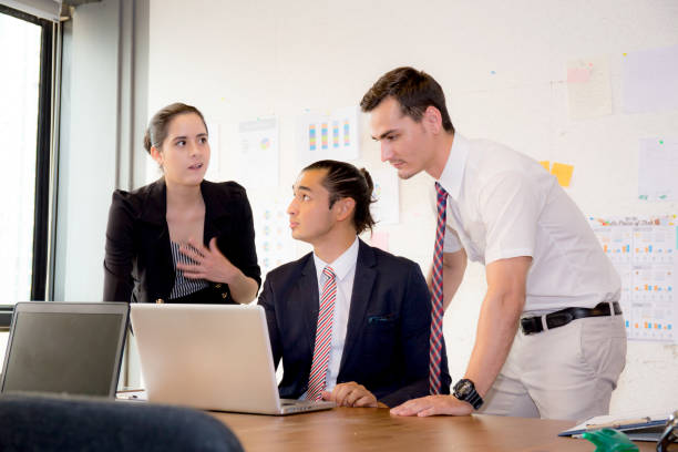 istock American people business team having using laptop during a meeting and presents. 832794592