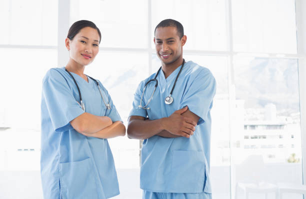istock Confident surgeons with arms crossed in hospital 832833722