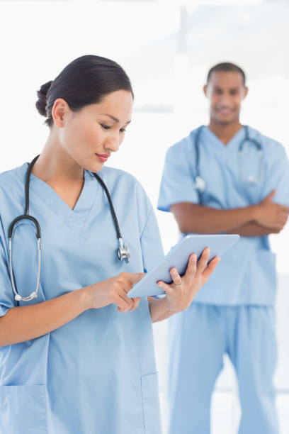 istock Beautiful female surgeon holding digital tablet 832834432