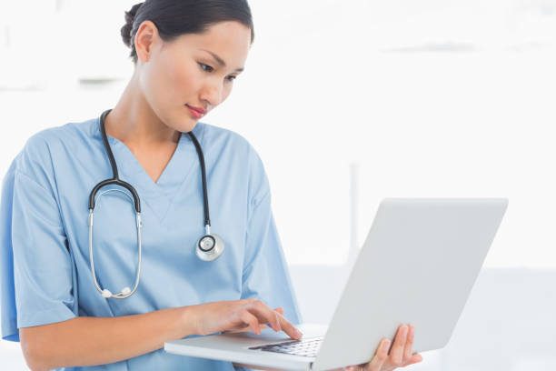 istock Concentrated surgeon using a laptop in hospital 832834668