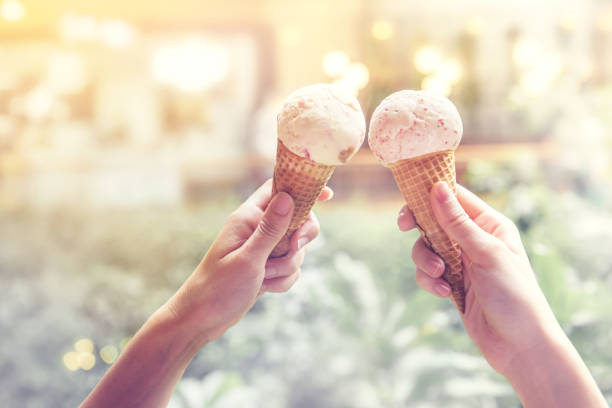 istock Woman hands holding ice cream cones on summer 832880422