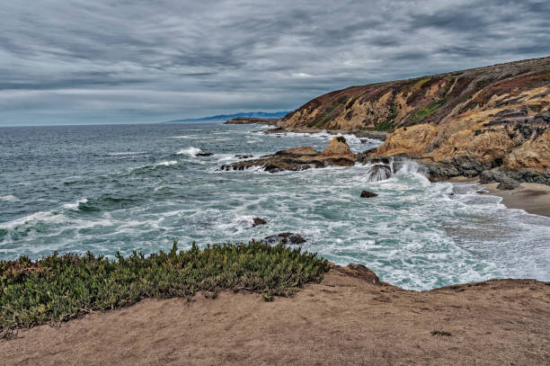 istock Waves crashing along Pacific Coasline under Cloudy Sky 832897986