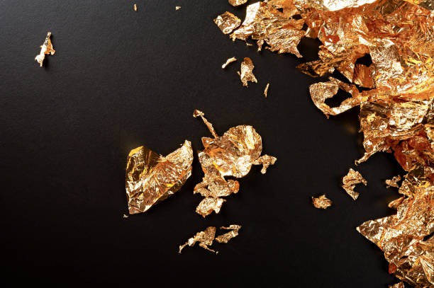 istock Gold background. Gold leaf texture isolated on black. 832942646
