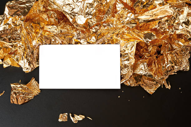 istock Gold background. White card on the gold leaf texture. 832942702