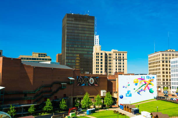 Downtown Akron Skyline with Akron Sign and Art Akron, United States - May 29, 2014:  Downtown Akron skyline with the words "Akron"on a sign in the center, and a colorful mural to the right. akron ohio stock pictures, royalty-free photos & images