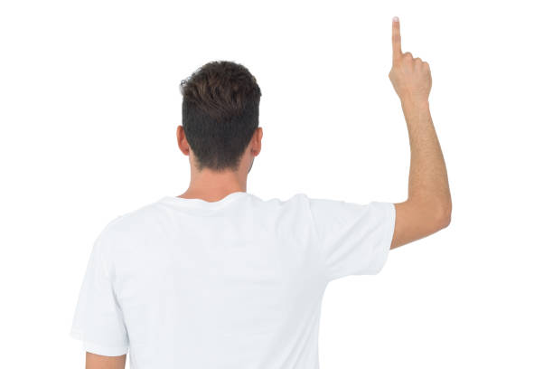 istock Rear view of a young man pointing upwards 832955510