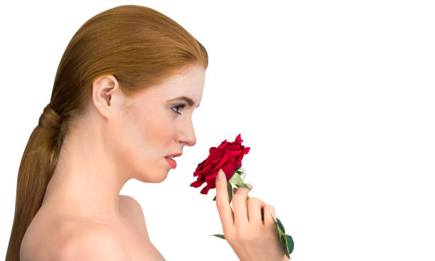 istock Natural beauty posing and smelling red rose 832961764