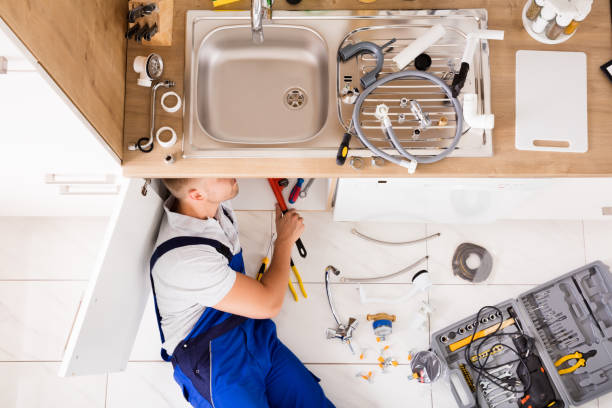 istock Male Plumber In Overall Fixing Sink Pipe 832975194