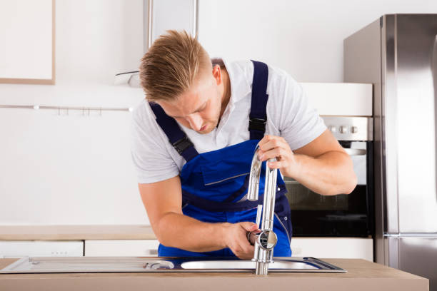 istock Plumber Fixing Faucet In Kitchen 832983328