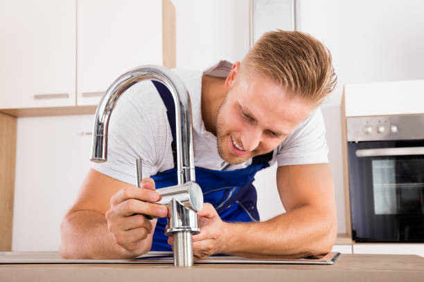 istock Plumber Fixing Faucet In Kitchen 832983334