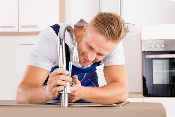 istock Plumber Fixing Faucet In Kitchen 832983342