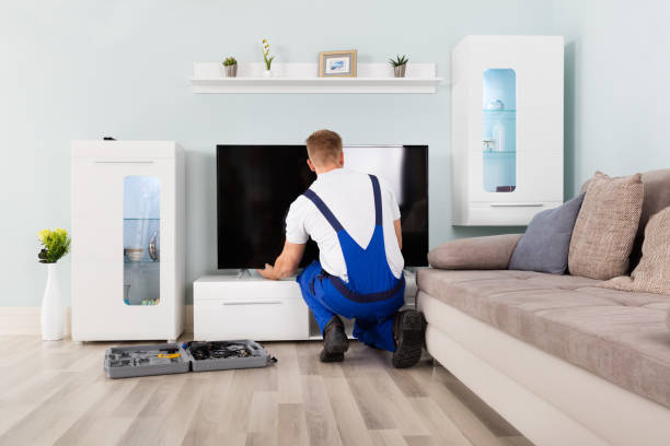istock Male Electrician Fixing Television 832983452
