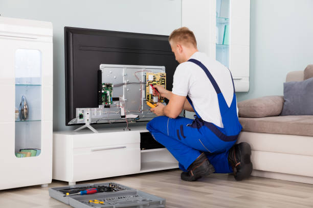 Electrician Checking Television Young Male Electrician In Overall Checking Television installing tv stock pictures, royalty-free photos & images