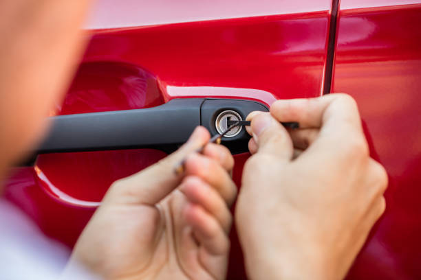 istock Person Opening Car Door With Lockpicker 832989888