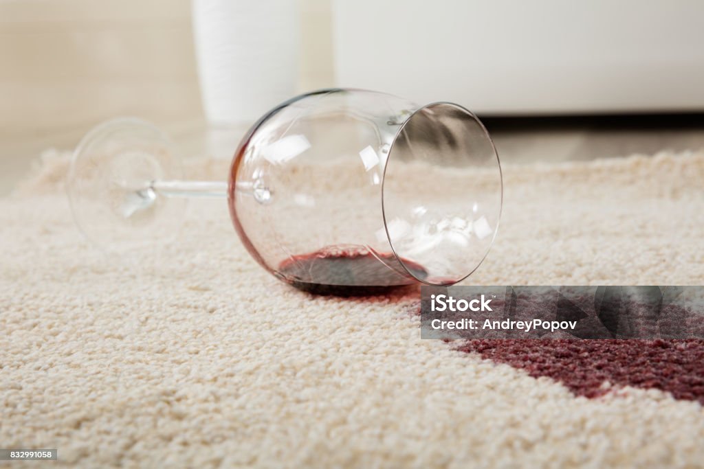 Red Wine Spilled From Glass On Carpet High Angle View Of Red Wine Spilled From Glass On Carpet Stained Stock Photo