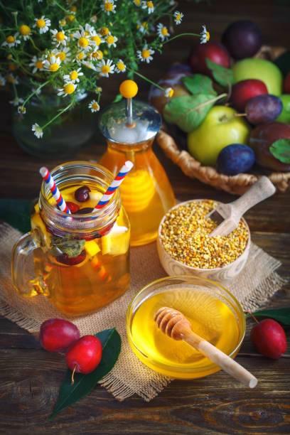 istock Fresh honey, field flowers, lemon tea and fruit on a wooden table. Selective focus 832997688