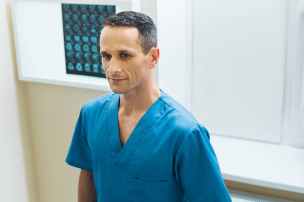 istock Handsome doctor standing in his CT scan lab 832998242