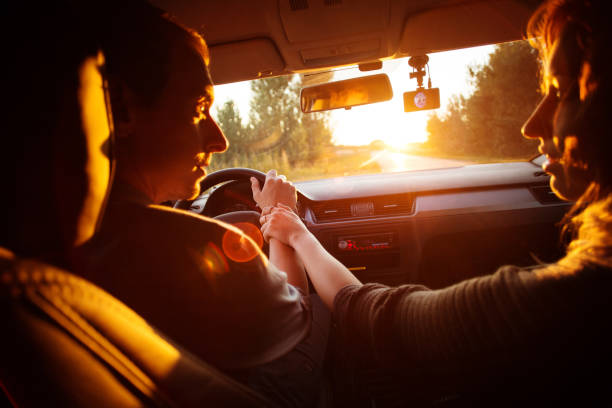 istock Couple driving car on way to sunset 833019934