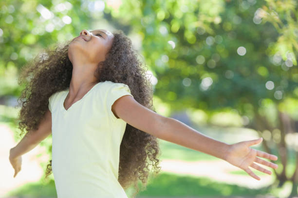 istock Young girl smiling with arms outstretched 833035080