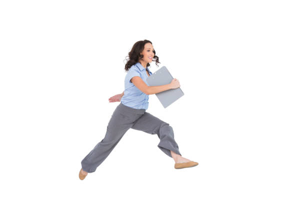 istock Cheerful classy businesswoman jumping while holding clipboard 833040222