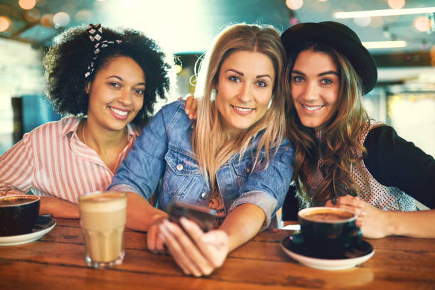istock Three attractive smiling young women friends 833048904