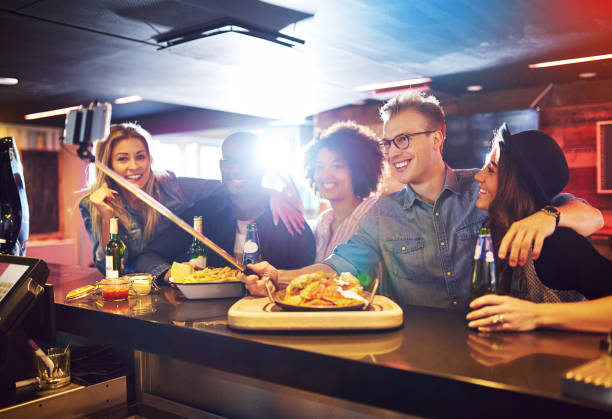 istock Cheerful people doing selfie in the bar 833049670