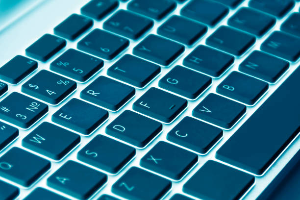 istock Close up view of a computer keyboard keys in blue tones 833049760