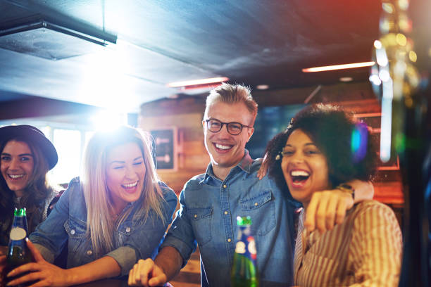 istock Laughing friends with beer at bar counter 833050898