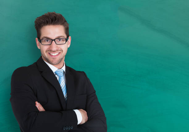 istock Businessman Standing Against Blackboard 833063422