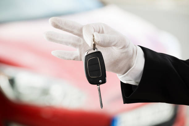 istock Valet Boy Hand Holding Car Key 833063526