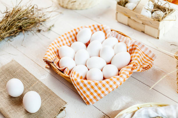 istock Chicken eggs in basket on wooden background 833064066