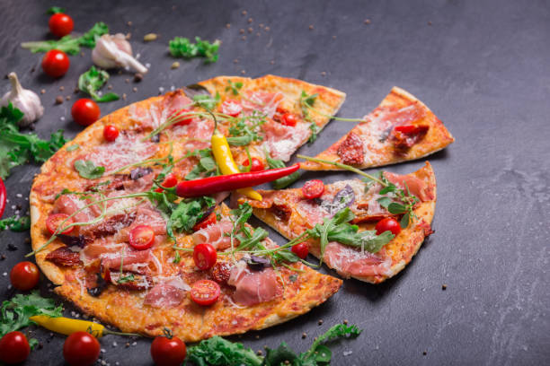 Delicious and colorful dish on a dark gray background. Traditional Italian pizza. Culinary concept. Copy space.