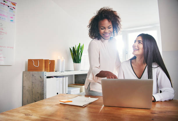 istock Two coworkers working on project at laptop 833071290