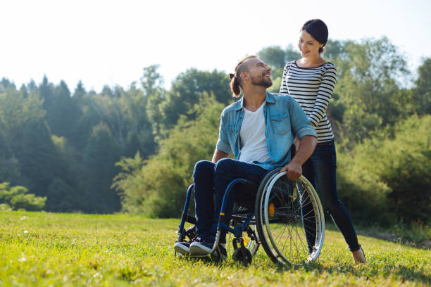 istock Man with disabilities and his wife exchanging loving looks 833071956