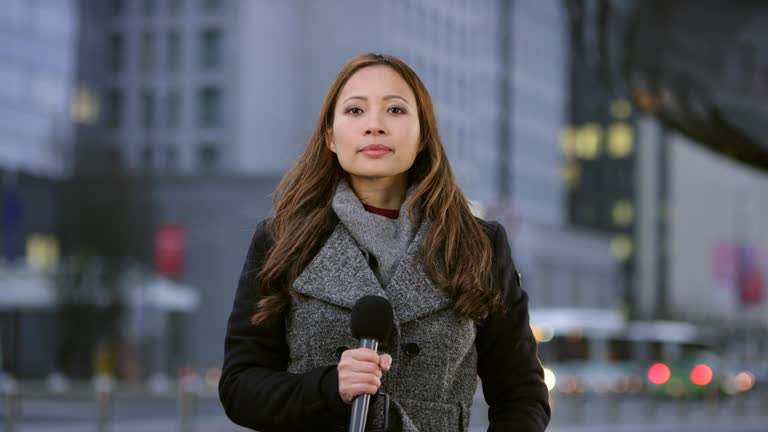 Asian female reporter live from the city center