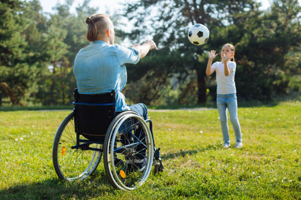 istock Man with disabilities playing volleyball with daughter 833078596