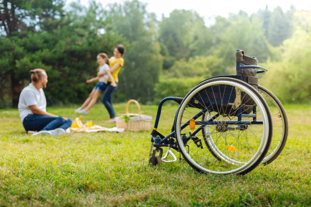istock Disabled man watching his wife spin daughter 833090554