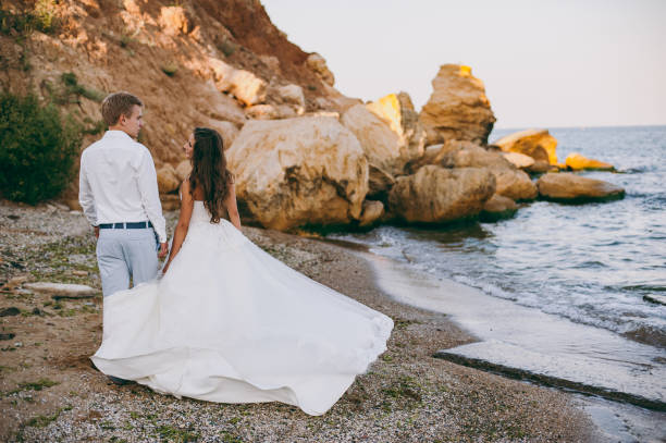 istock Beautiful wedding couple on a walk by the sea 833091812