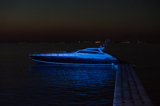 luxury Motor yacht on marina over sunset in the night
