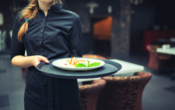 istock Waiters carrying plates with food, in a restaurant. 833113702