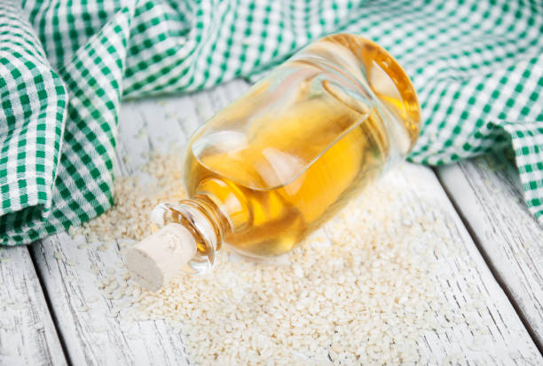 istock Sesame seeds and bottle with oil 833119244